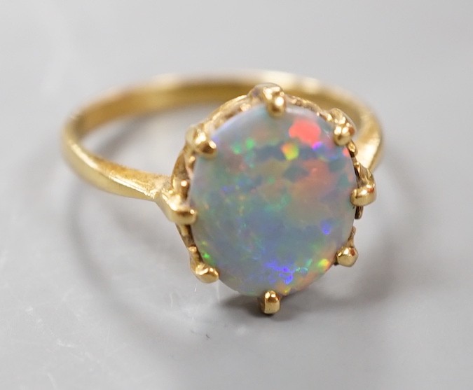 A modern 18ct gold and oval black opal set ring, size P/Q, gross weight 3.6 grams.